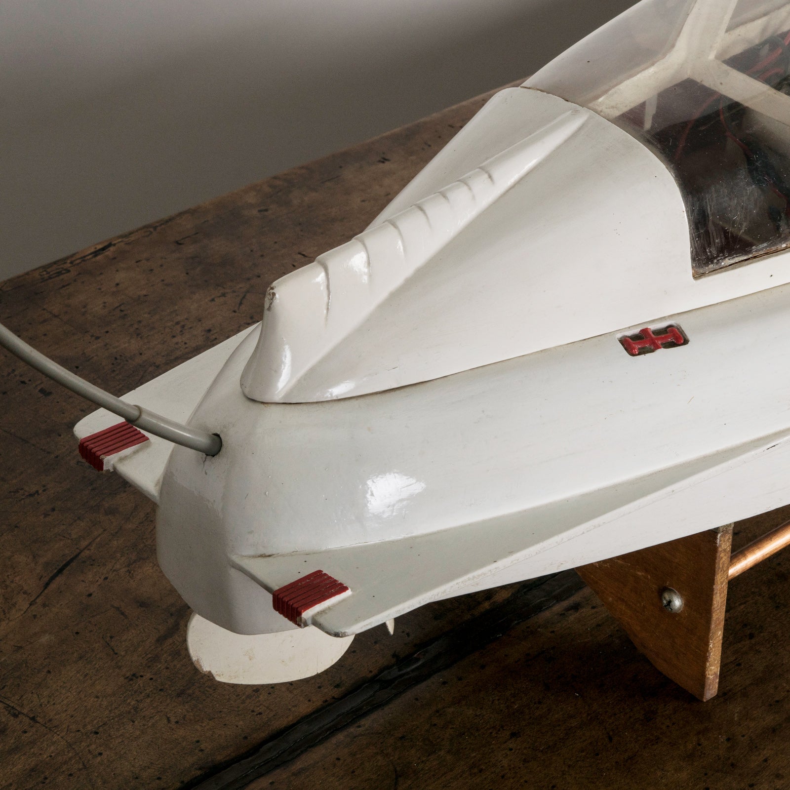 Close-up of a superb vintage French scale model of a speed boat, meticulously handcrafted to replicate the iconic Plymouth motorboat. Made from light-toned wood with fine detailing, this elegant piece captures nautical charm at its best. Available at Wildschut Antiques.