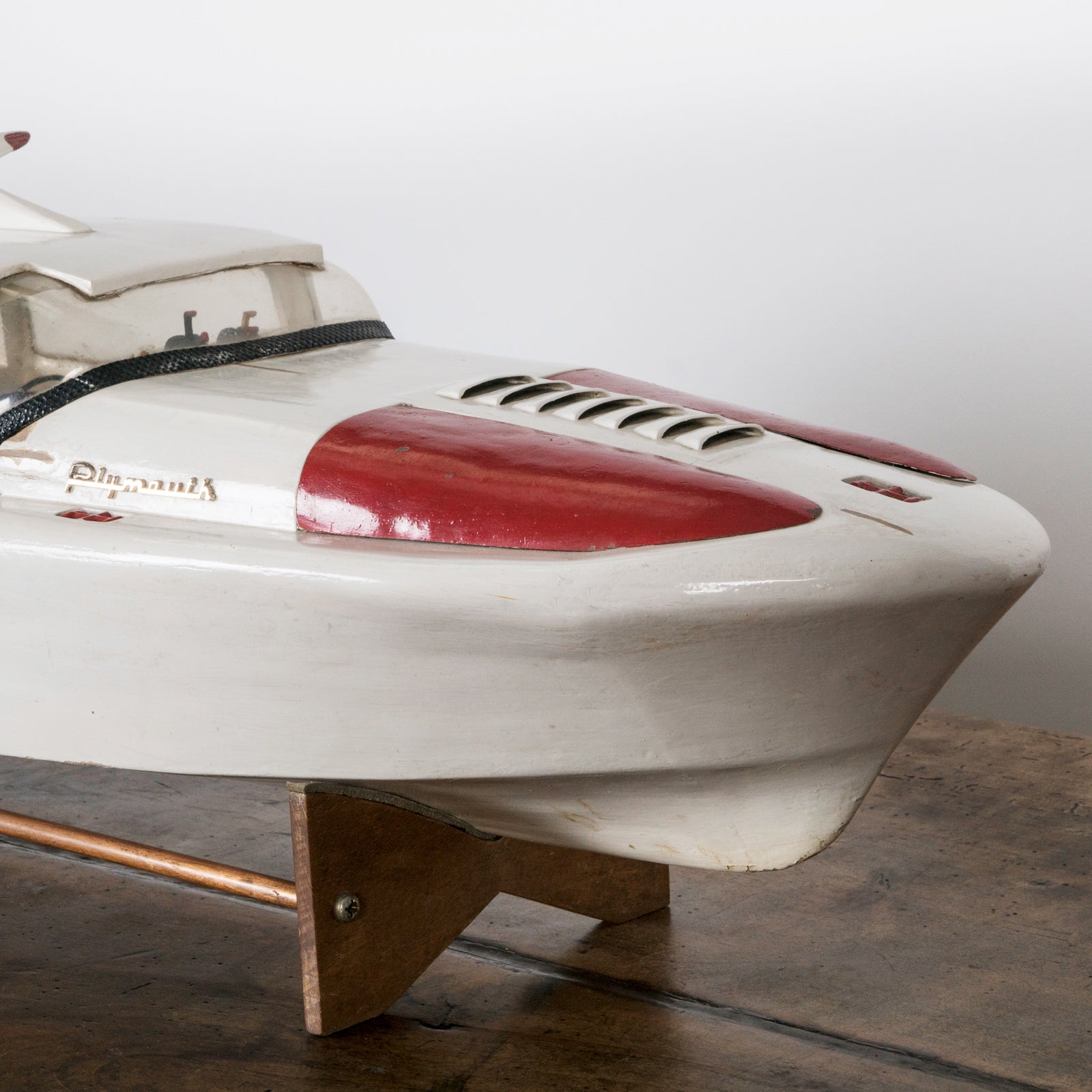 Close-up of a superb vintage French scale model of a speed boat, meticulously handcrafted to replicate the iconic Plymouth motorboat. Made from light-toned wood with fine detailing, this elegant piece captures nautical charm at its best. Available at Wildschut Antiques.
