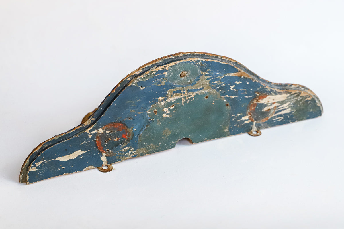 Detail of a small antique French carved and gilded wall bracket, with original paint and a richly aged patina in red, blue, and gold tones.