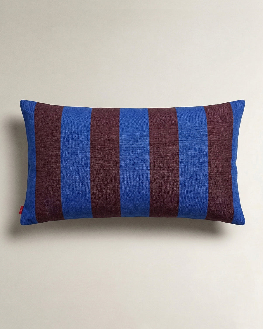 Striped blue and brown pillow on a beige background