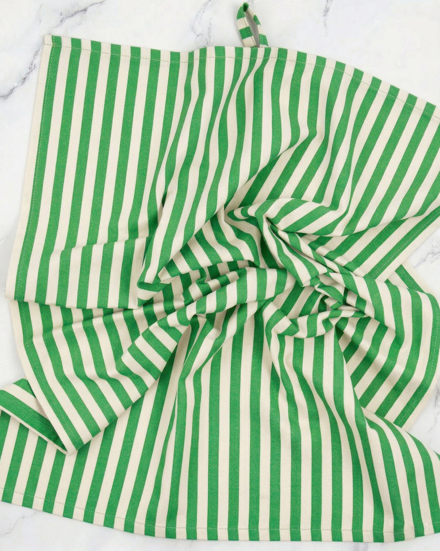 Green and white striped towel on a marble surface, available via Wildschut Antiques.