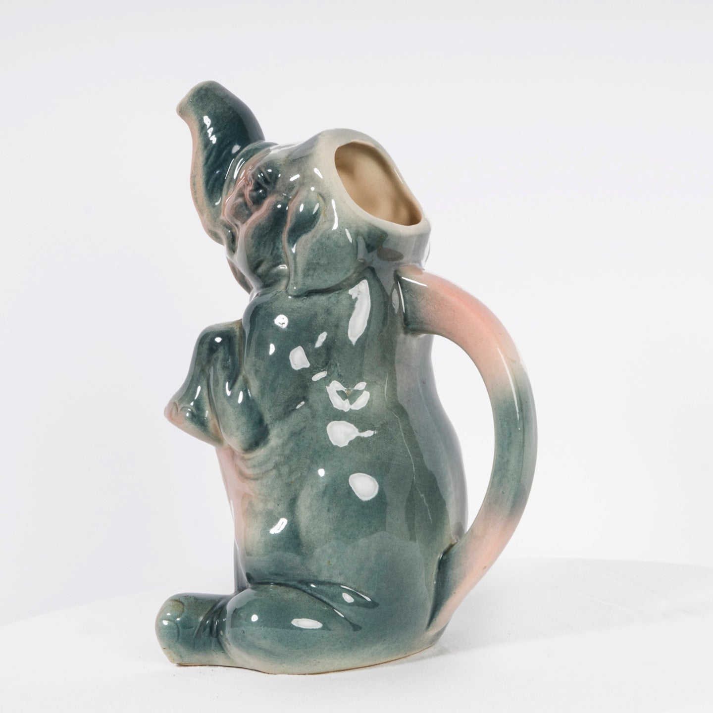 Sideview of a vintage French majolica pitcher designed as a decorative elephant.