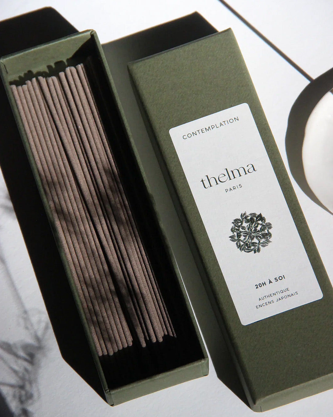 A box of Thelma Paris brand incense sticks with sandalwood and cypress fragrance, titled 'contemplation'