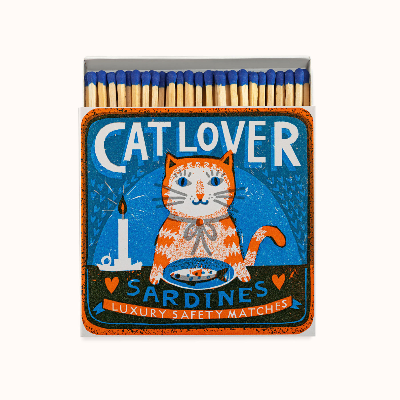 Matches with a cat-themed design and 'Cat Lover' text. A plate with a sardine in front of the cat and a candle next to it. Design by Archivist Gallery, available at Wildschut Antiques.