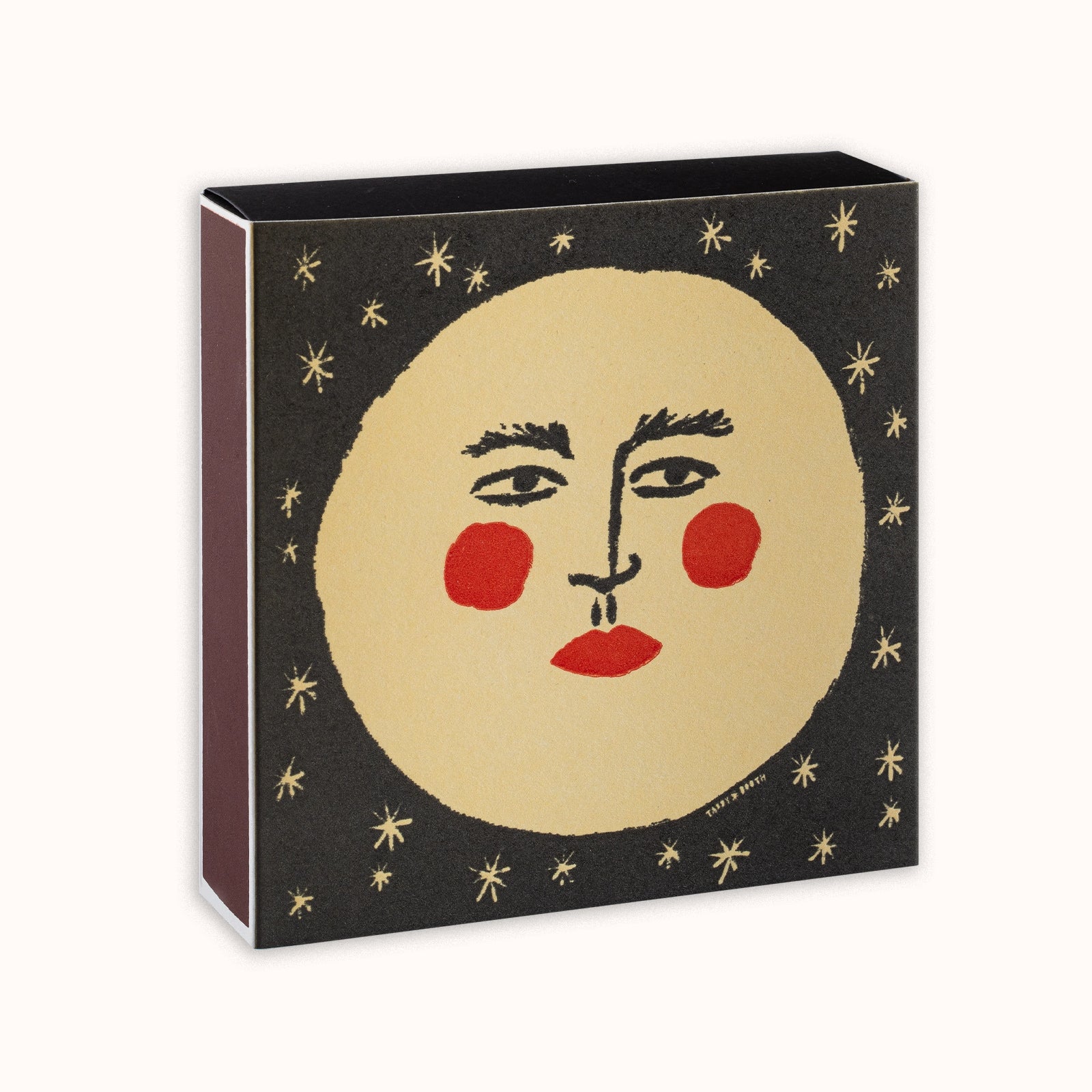 Matches in a decorative Archivist Gallery matchbox featuring a moon with a face and red cheeks, set against a black background, available at Wildschut Antiques.
