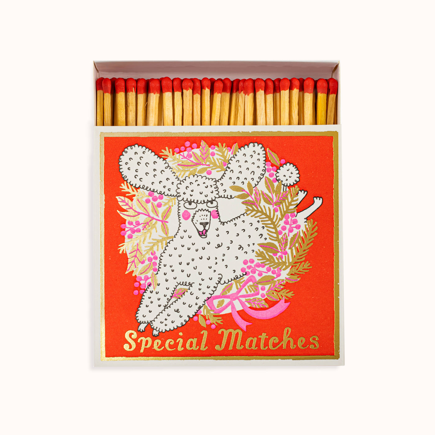 A box of Archivist Gallery luxury matches with a colorful design featuring a playful poodle, and decorative elements on a red background. Part of the Archivist Gallery Collection, available at Wildschut Antiques.