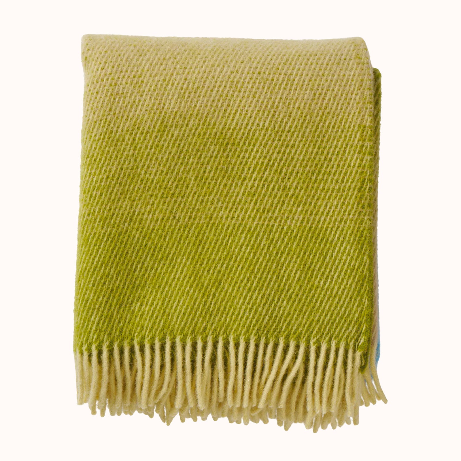 Green wool throw blanket with beige fringe on a white background