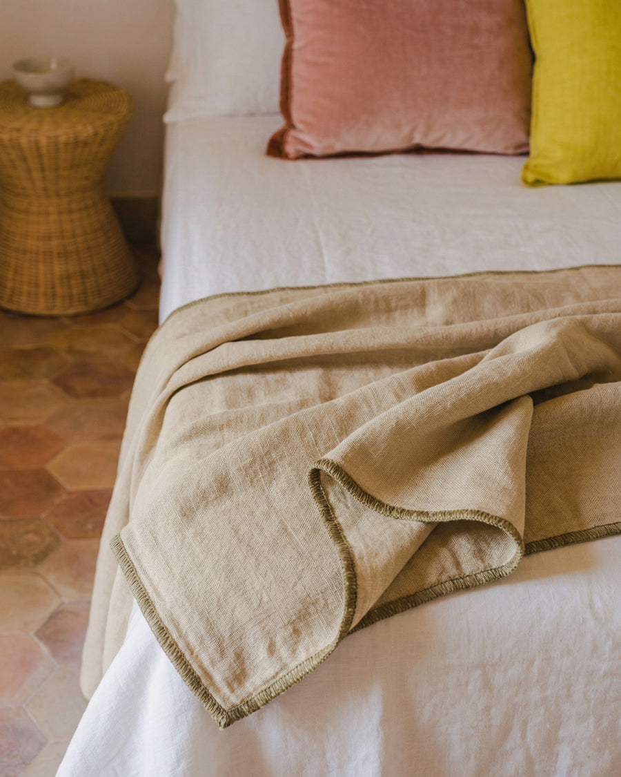 Close-up of a soft pink linen bed throw. Available via Wildschut Antiques.