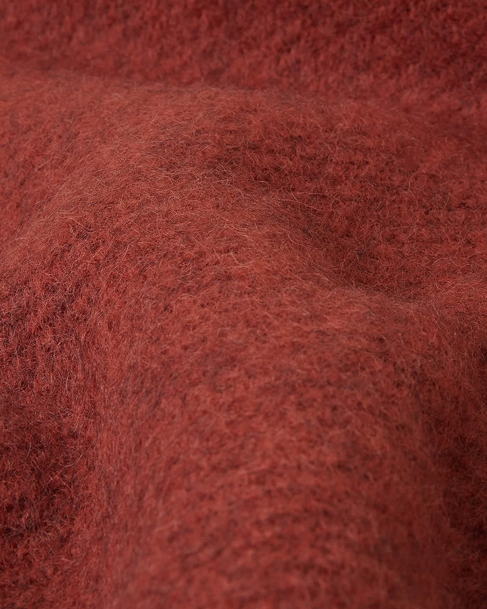 Close-up of a textured rust coloured  wool surface belonging to a wool throw blanket by Klippan 1879, available at Wildschut Antiques.