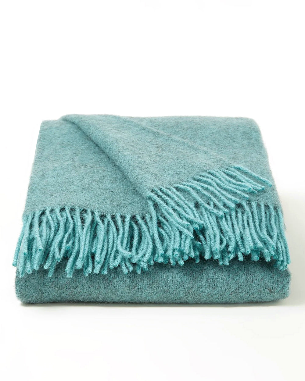 Neatly folded turquoise green blue wool blanket with fringes on a white background, by Klippan 1879, available at Wildschut Antiques.