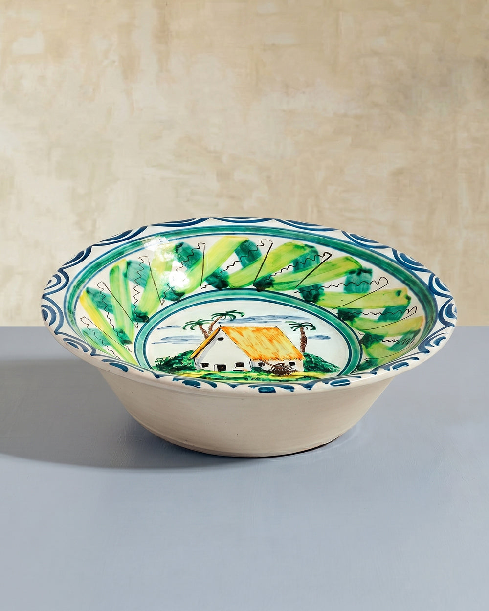 Large vintage Italian decorative ceramic bowl with green and blue patterned design, displayed on a beige background, available at Wildschut Antiques.