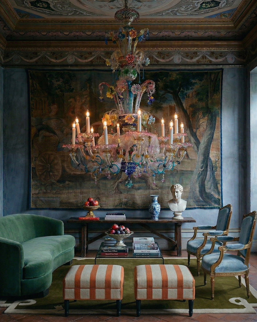 Luxurious interior with a large vintage Venetian Murano Glass chandelier, green sofa, and decorative elements, available via Wildschut Antiques.