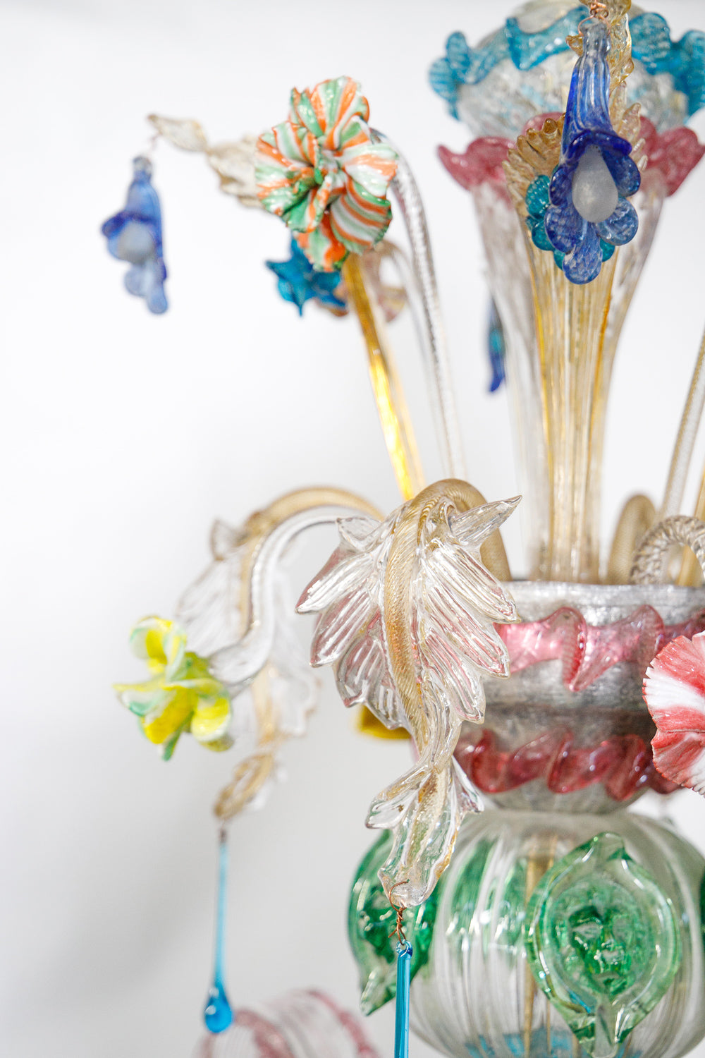 Colorful glass flower arrangement with decorative elements on a white background, part of a colorful vintage Venetian Murano Glass chandelier, available via Wildschut Antiques