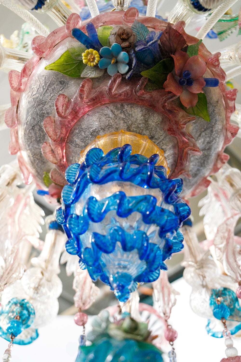 Decorative glass ornament with blue floral designs on a white background, belonging to a colorful vintage Venetian Murano Glass chandelier, available via Wildschut Antiques