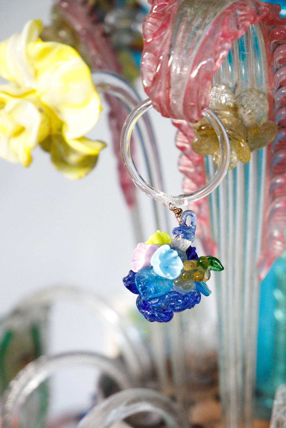 Colorful glass flower charm on a clear ring, part of a colorful vintage Venetian Murano Glass chandelier, available via Wildschut Antiques