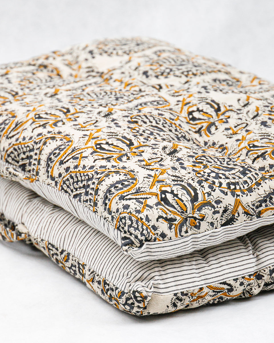 Folded mattress pillow with floral paisley pattern on a white background available at Wildschut Antiques