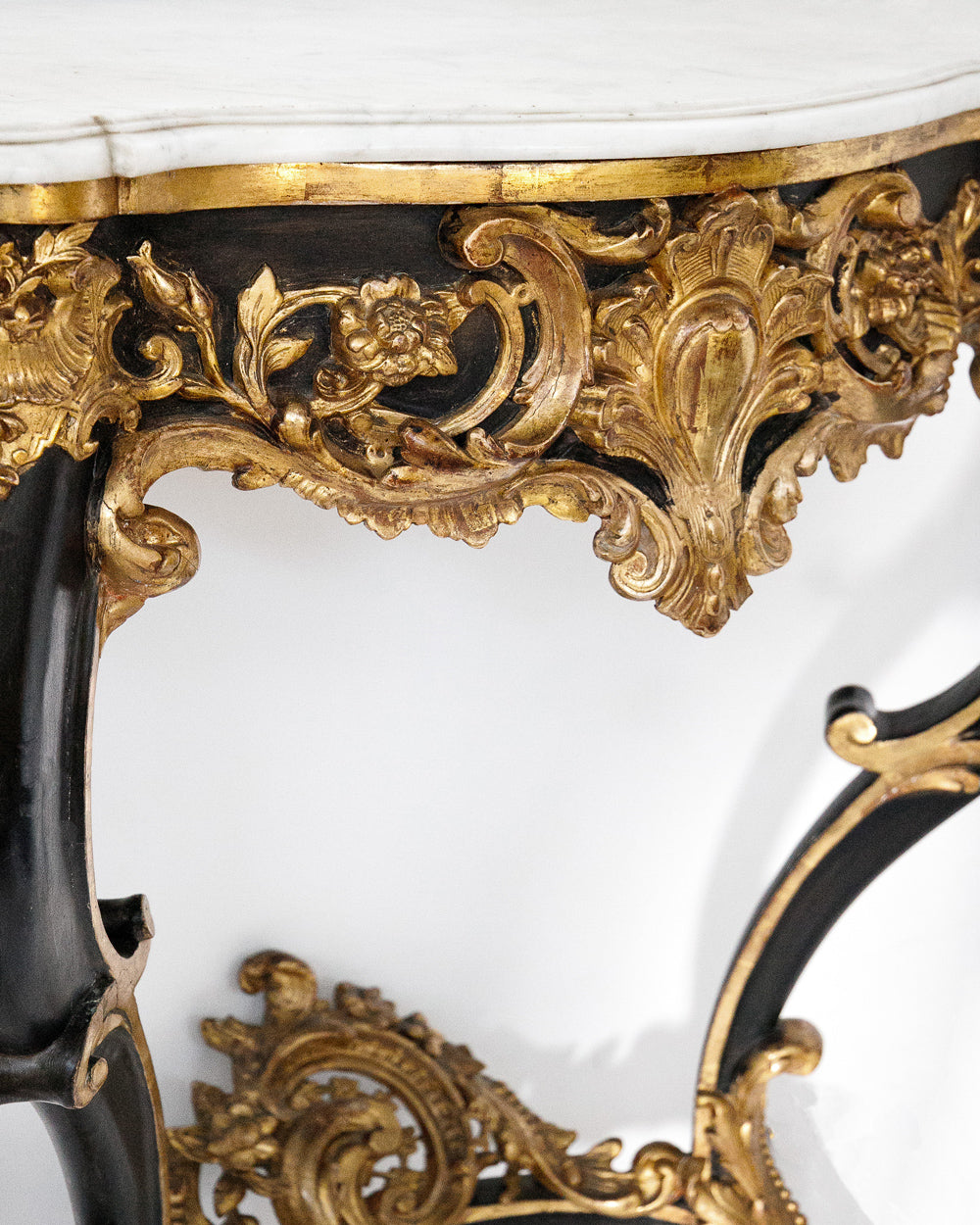 Detail of a very decorative antique Napoleon III style console table with gold and black embellishments and white marble top, available via Wildschut Antiques