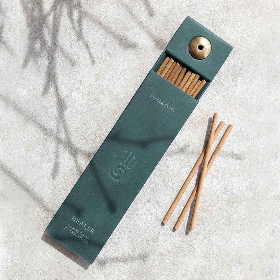 Incense sticks in a teal box on a light surface