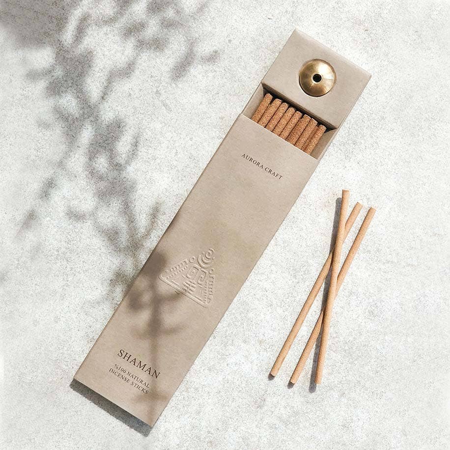 Incense packaging with incense sticks on a textured surface