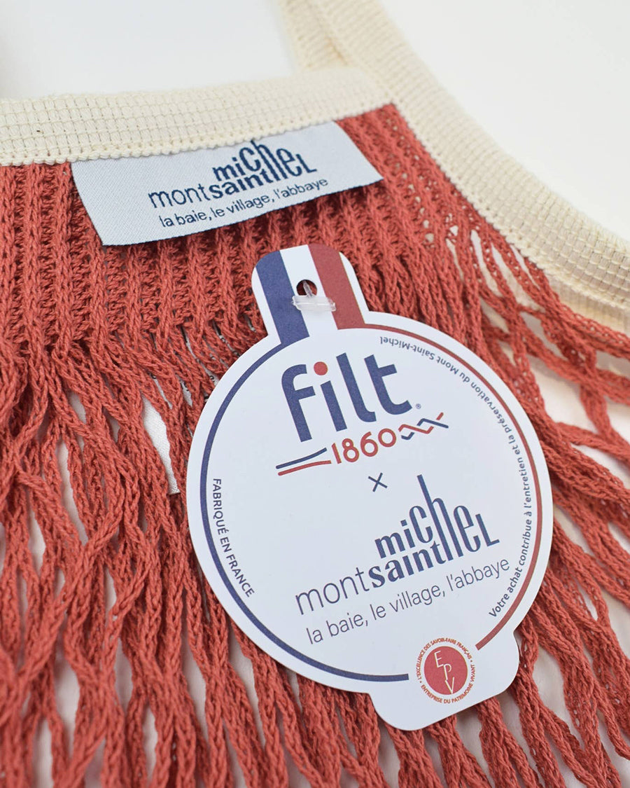 Filt 1860 and Mont St. Michel label on a red mesh bag. 