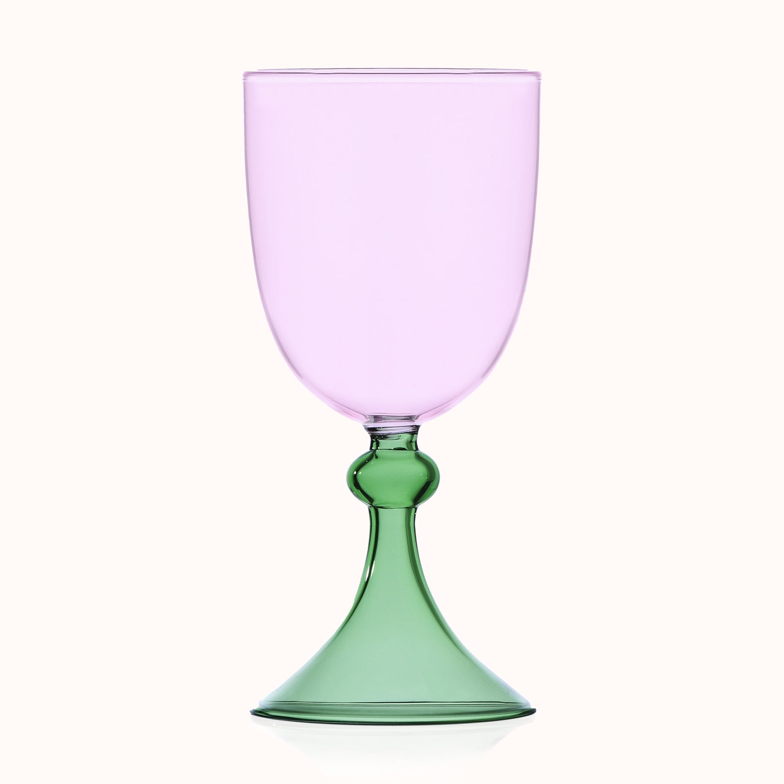 Glass with pink top and green base on a white background