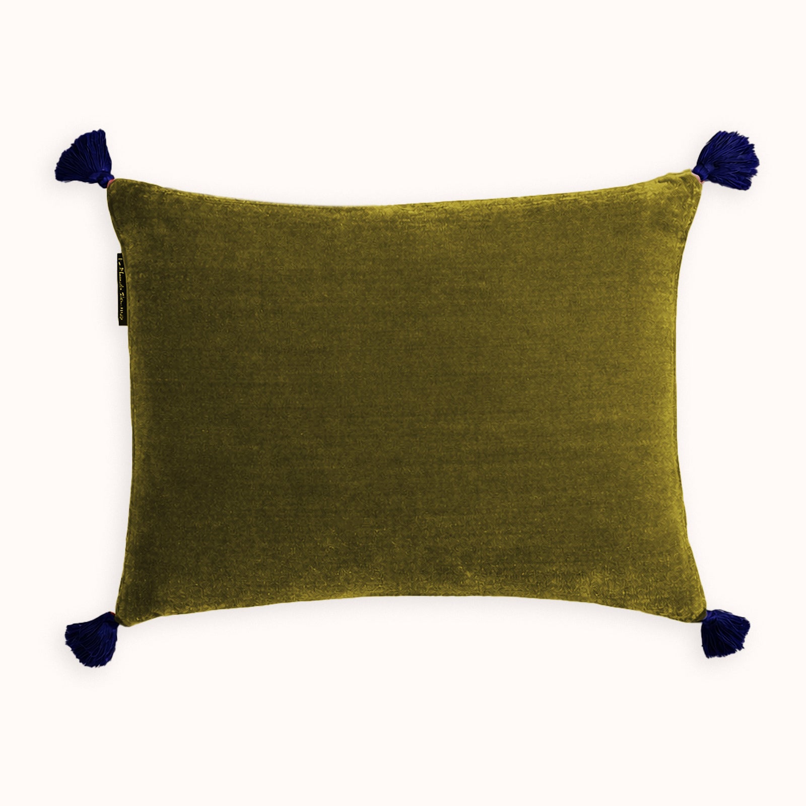 Olive green silk velvet velour cushion with contrasting pom-pom tassel details on a white background. Designed by Monde Sauvage Paris, available at Wildschut Antiques.
