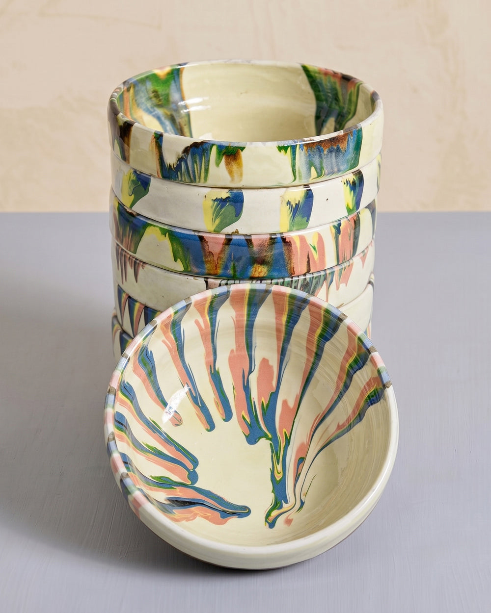 Set of vintage ceramic bowls with colorful marbled design on a neutral background, available at Wildschut Antiques.