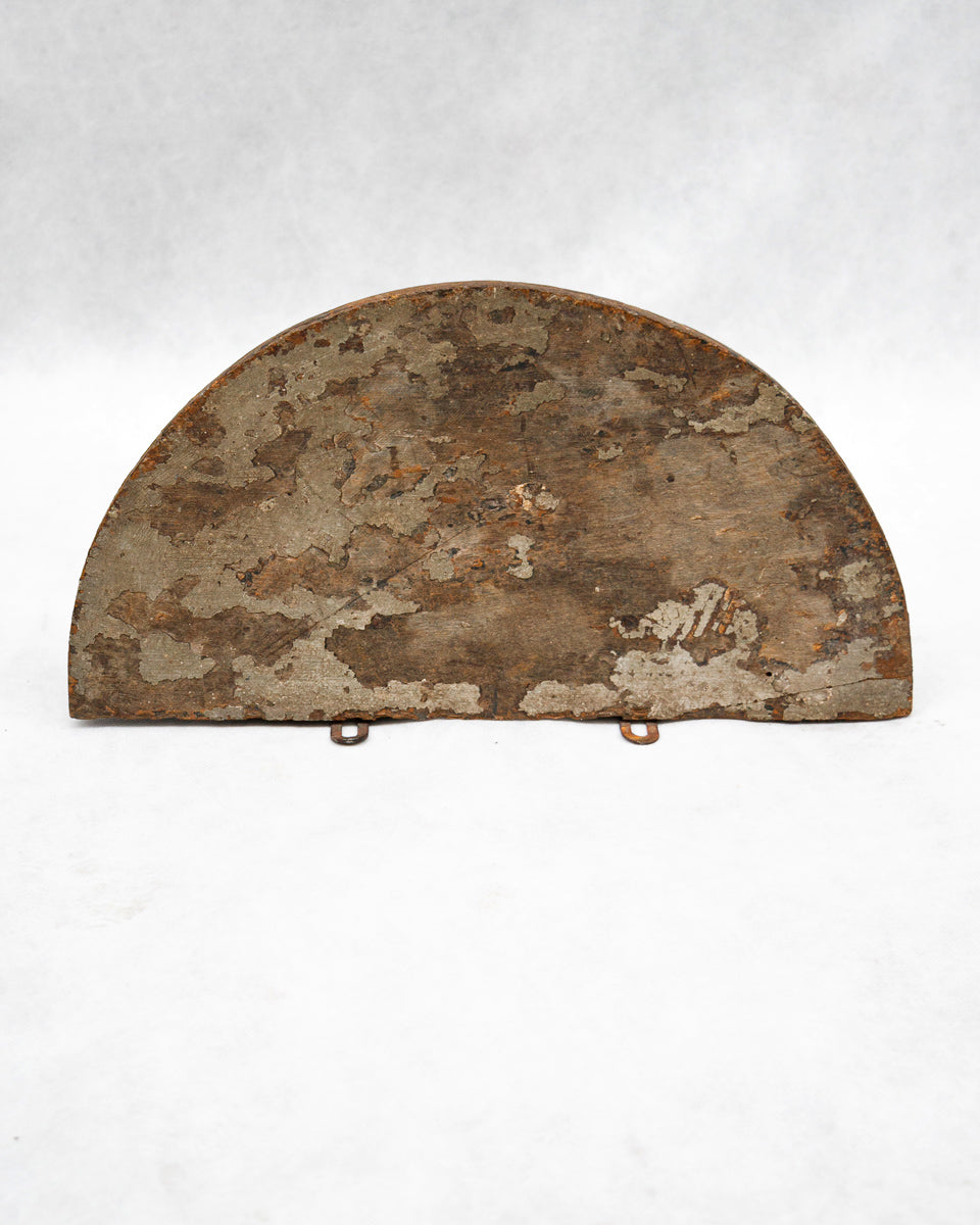 Rust-colored half-moon-shaped metal object on a white background