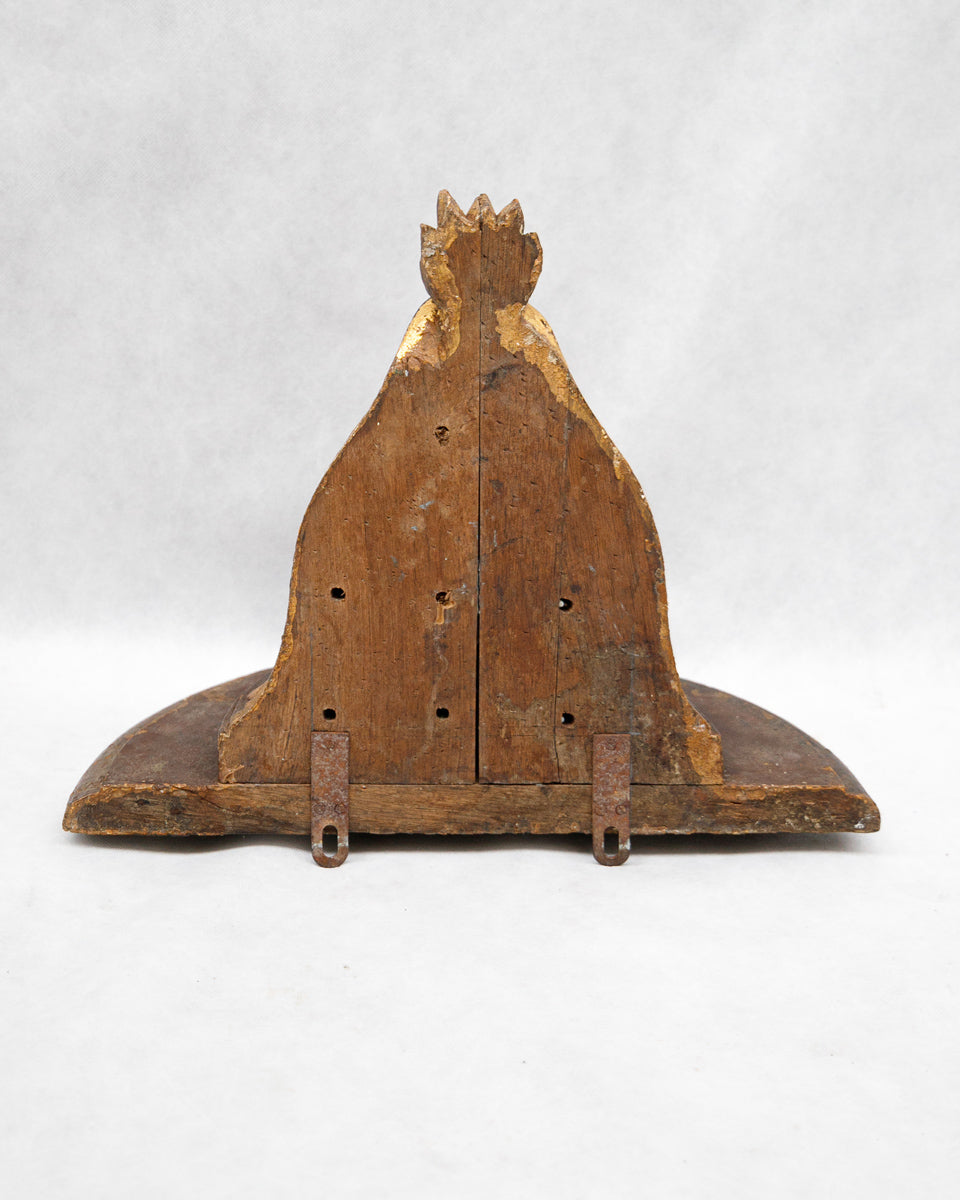 Wooden object with a crown-like top on a white background