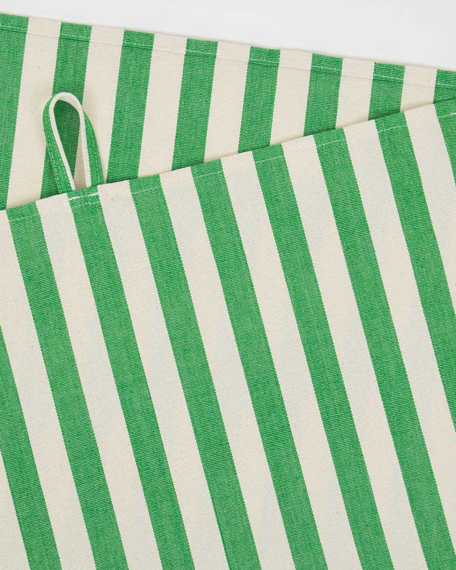 Close-up of a green and white striped towel with a visible handle on a white background, available via Wildschut Antiques.