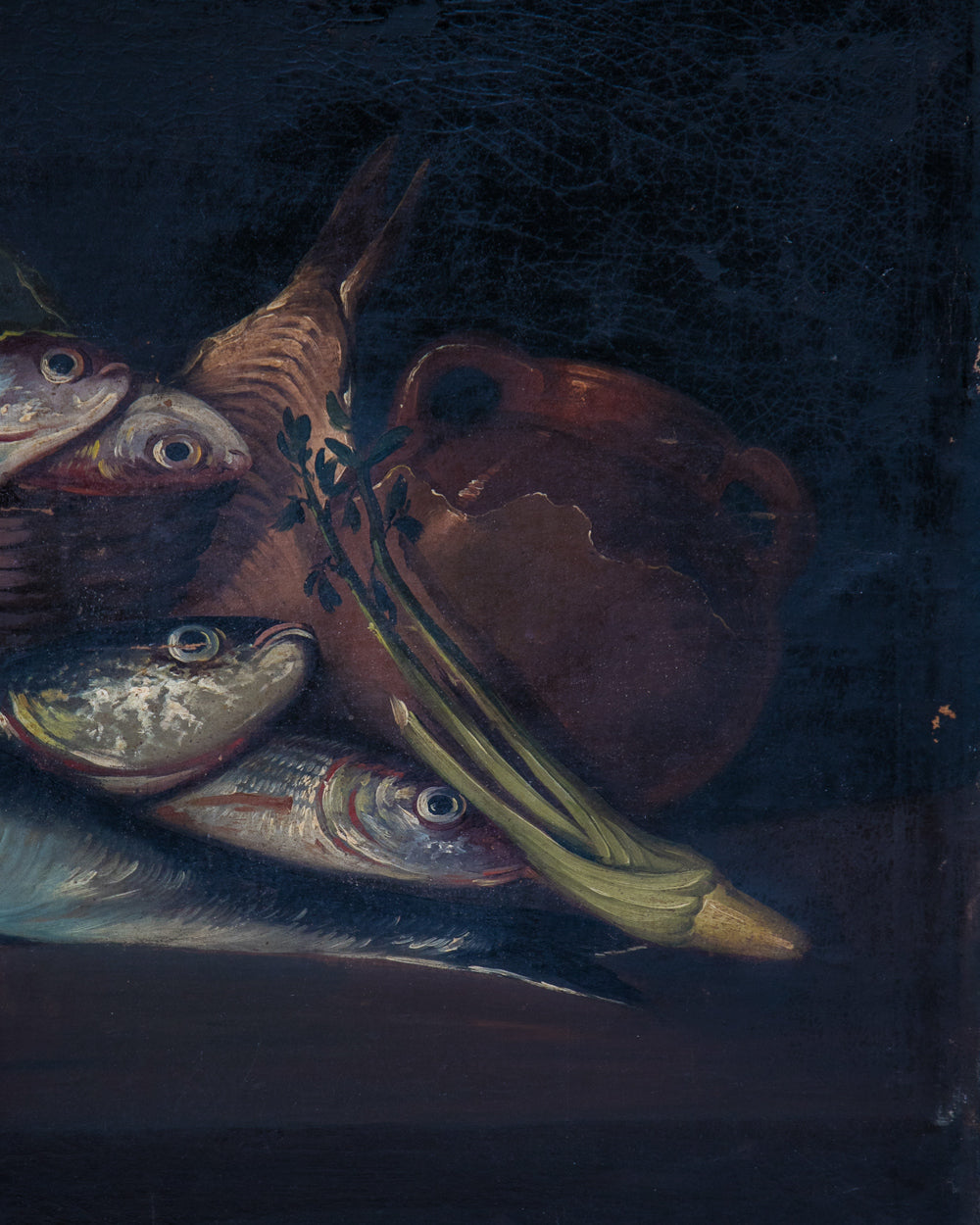 A dark still life painting showing several fish, a brown earthenware jug, and green vegetables against a very dark background. Detail of a Pair of Neapolitan Fish Still Lifes, 19th Century, available via Wildschut Antiques.
